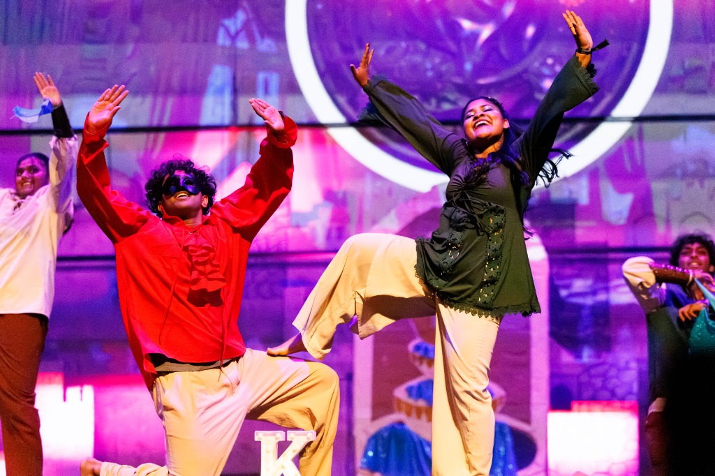TAMU Akh Mastani dancers performing high-energy choreo on stage