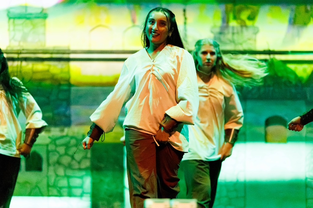 TAMU Akh Mastani dancers in white shirts performing synchronization choreography