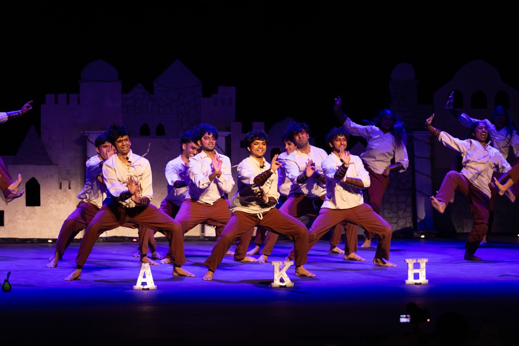 TAMU Akh Mastani dancers in low crouching dance pose