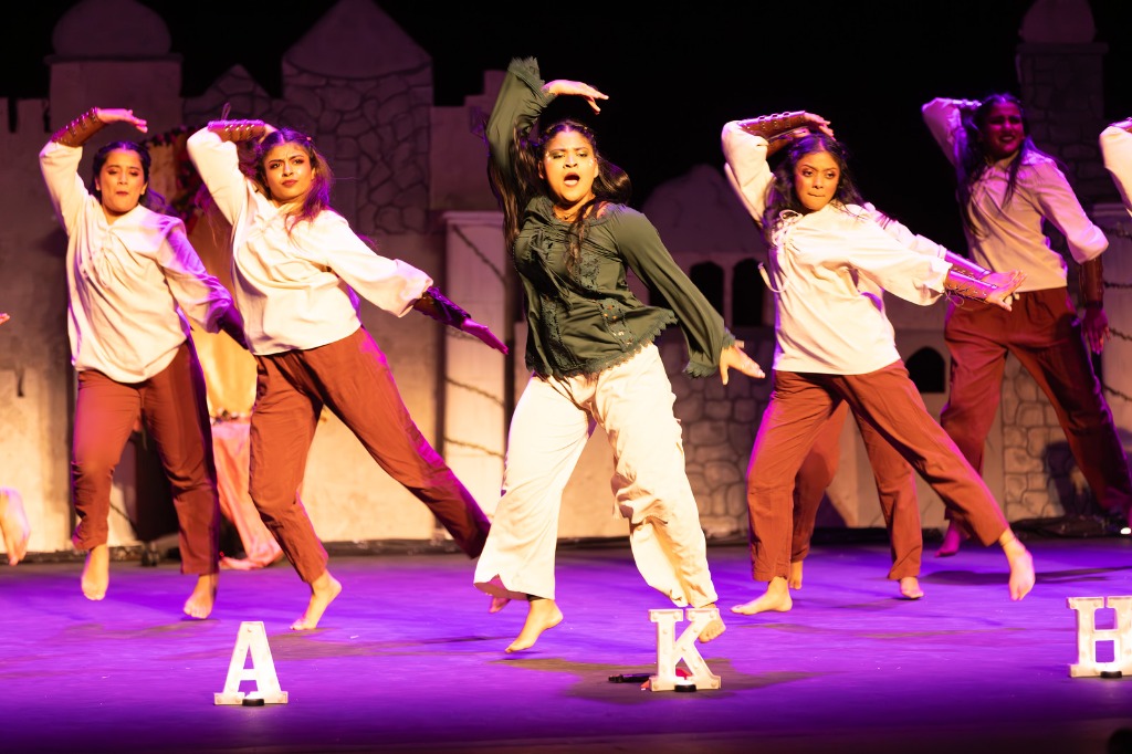 TAMU Akh Mastani female dancers performing dynamic choreography poses